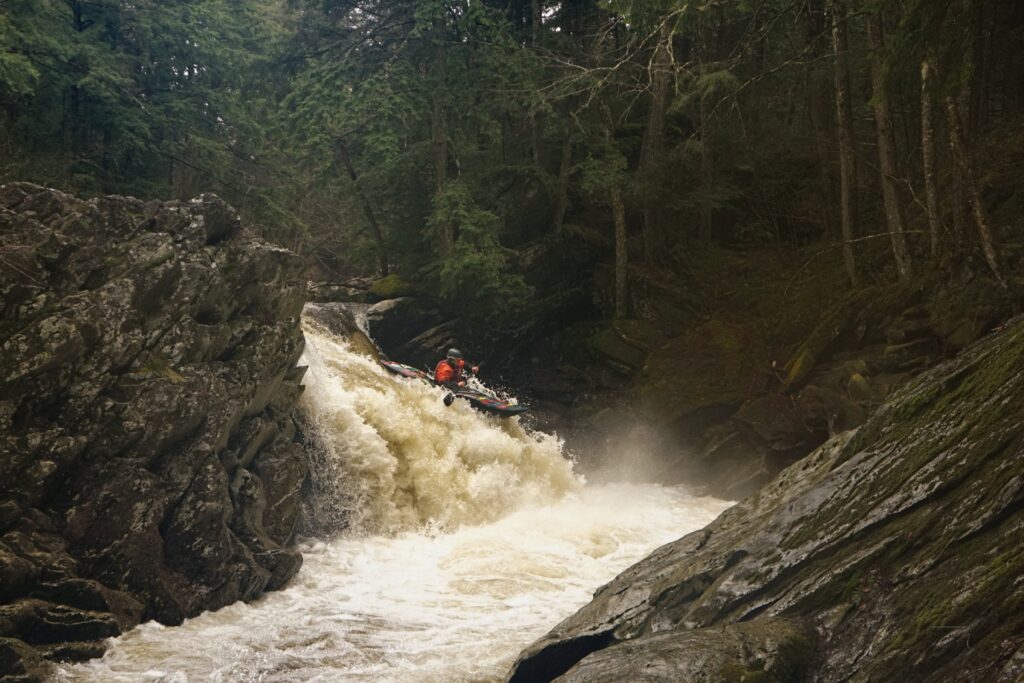 Kayaker Mike Mainer descends a waterfall on the Upper New Haven River in South Lincoln Vermont Whitewater Kayaking