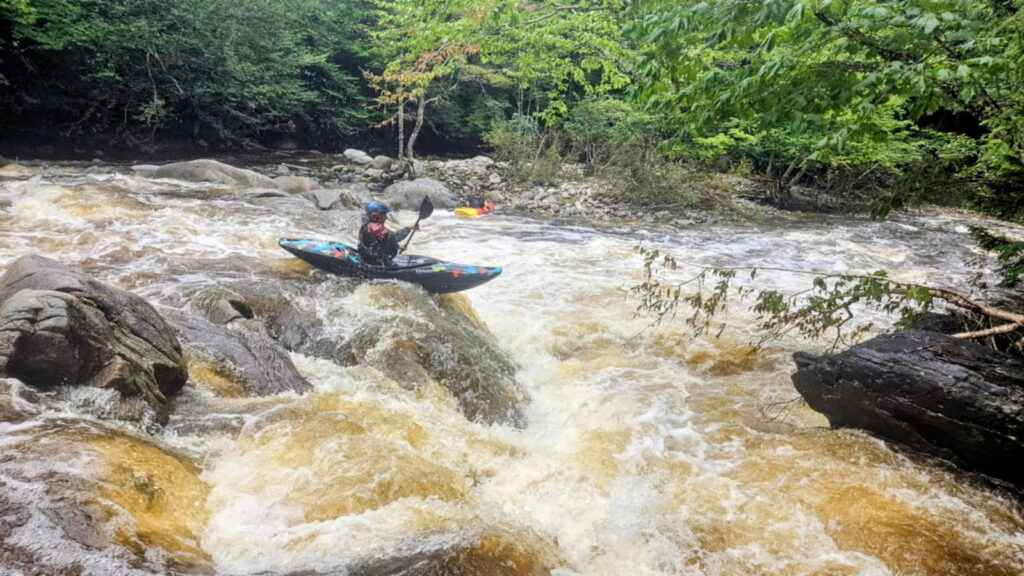 Kayaker descending a rapid on the Moose River above Victory Vermont